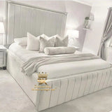 Cosy bedroom styled with a high-sided upholstered bed frame