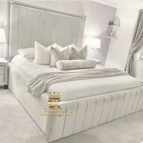 Cosy bedroom styled with a high-sided upholstered bed frame